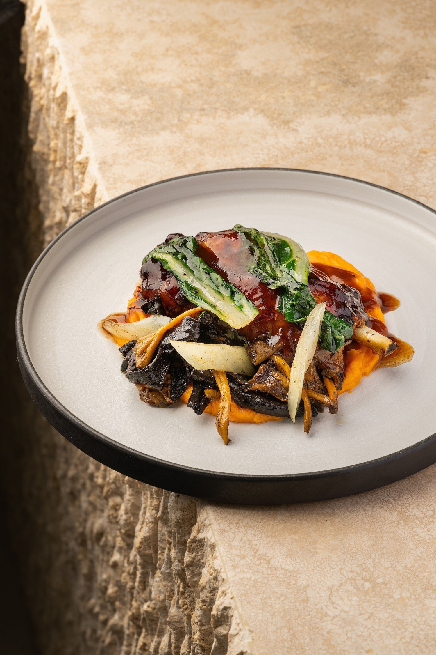 Low-Temperature Pork Shank with Laumont Truffle Honey, Pan Jus, Sweet Potato Cream, Swiss Chard, and Sautéed Mushrooms