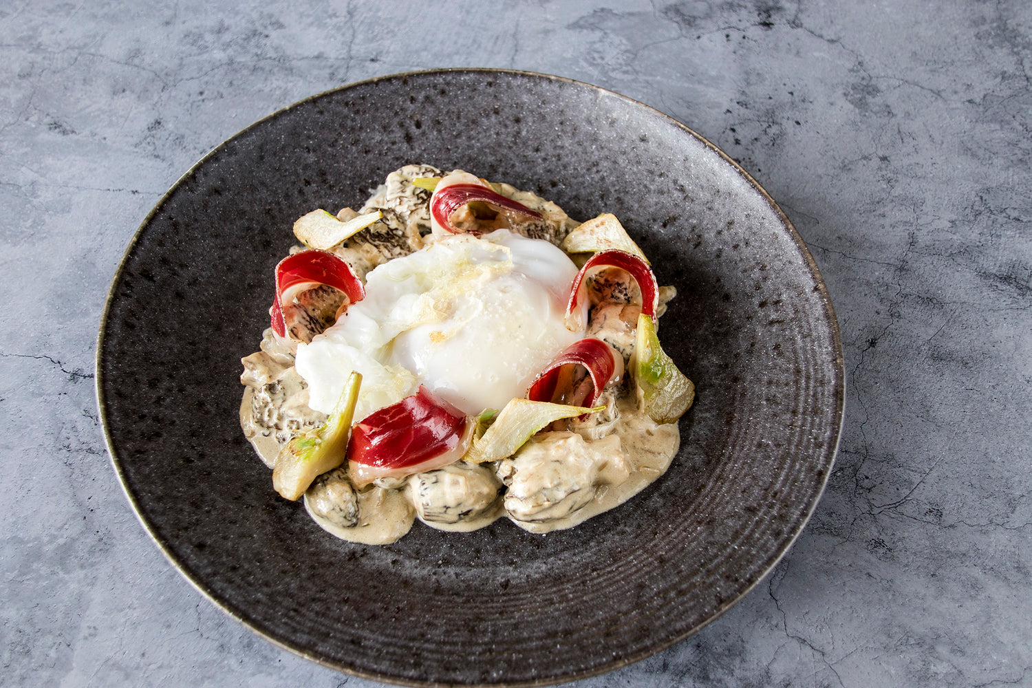 Fried goose egg with morels